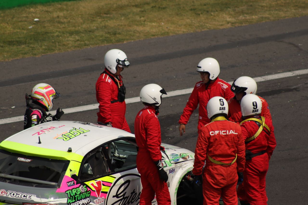 who-we-are Race crew with driver after a race event in Ciudad de México, Mexico.